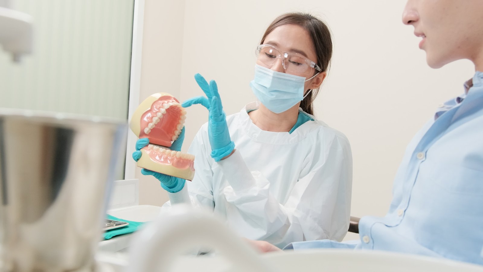 Dentist examining a patient's smile at Ivory Dental Clinic